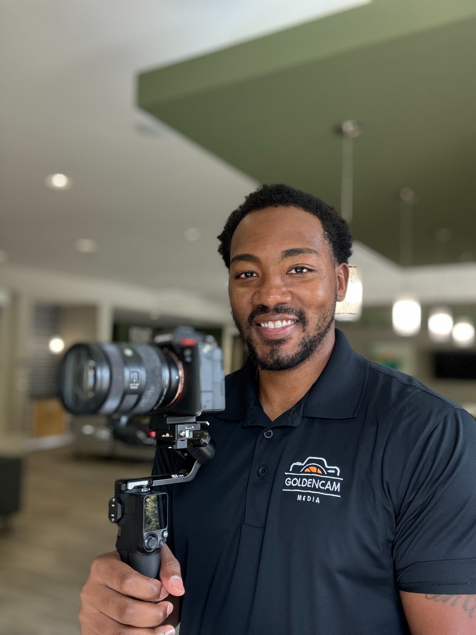 Cameron Bickley, founder of GoldenCam Media, holding his camera